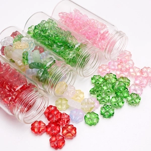 Colorful translucent clover and flower loose beads spilling from glass jars for DIY jewelry