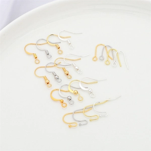 Assorted gold and silver plated earrings hooks for DIY jewelry making displayed on a plate
