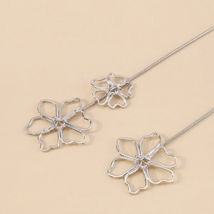 Detailed macro view of silver alloy flower pendant necklaces with sleek snake chain link