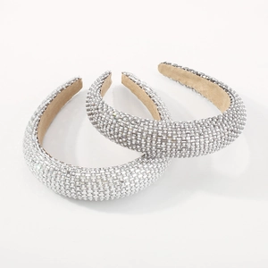 Luxurious wide headband with rhinestones and white pearls on minimalist white background