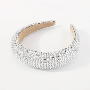 Close-up of luxury wide headband featuring white faux pearls and clear square crystals