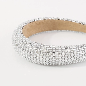 Luxurious padded headband featuring white faux pearls and shimmering rhinestone crystals