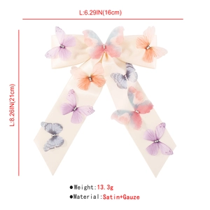 Detail view of large 21x16cm cream satin bow hair clip with colorful organza butterflies
