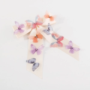 Elegant off-white satin bow hair clip with colorful mesh butterflies and crystal accents