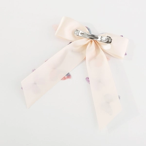 Pink satin butterfly hair bow with spring clip and rhinestone detail on white background