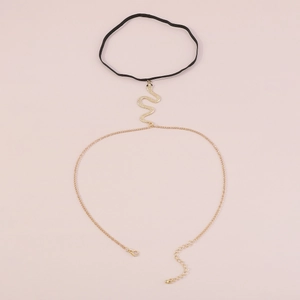 Détail d'une chaîne de cuisse gothique en cuir avec pendentif serpent doré et lien ajustable