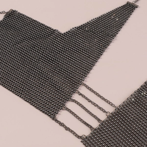 Close-up of black metal mesh body chain with sparkling rhinestones and chain link details