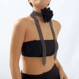 Detailed shot of black mesh choker with rhinestones and large fabric rose flower