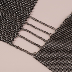 Macro view of black mesh body chain with sparkling rhinestones and metal link chains