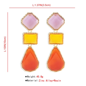 Detailed view of long geometric resin drop earrings with pink, yellow and orange colors