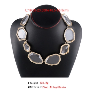 Detail of grey resin geometric necklace with chunky gold-tone zinc alloy frames