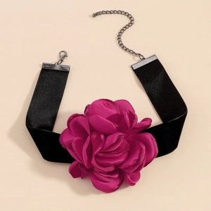 Macro detail of a large fabric rose flower on a black velvet choker necklace