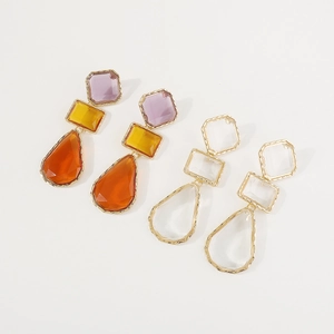 Detail of vintage geometric resin earrings with gold-plated edges in colorful and clear styles
