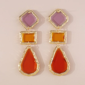 Detailed view of tiered geometric resin drop earrings with vintage brushed gold frames