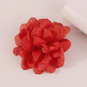 Detailed top view of a handmade red fabric rose brooch with satin layered petals
