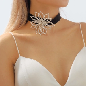 Detailed close-up of a velvet choker with a handcrafted 3D pearl and bead flower