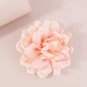 Detailed macro view of soft pink fabric layers on the elegant rose floral brooch
