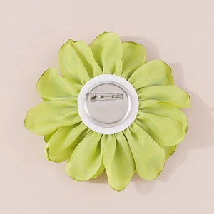 Detail view of the secure metal pin back and layered green fabric rose flower brooch