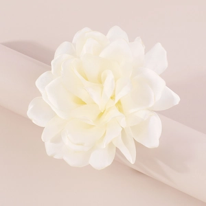 Close-up of white fabric rose brooch showing delicate layered petals and silk texture