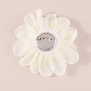 Detailed back view of white fabric rose brooch with metal pin and satin textures