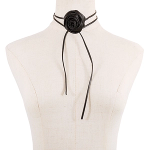 Detail of a handmade black fabric rose choker featuring dual wax cord ties on a model
