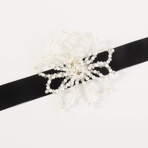 Close-up of handmade pearl flower necklace with black velvet ribbon and beaded petals