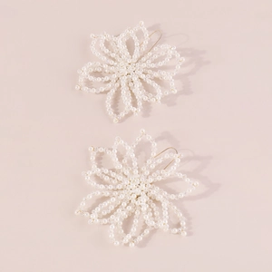 Macro view of floral hair accessories with white pearls and clear faceted beads