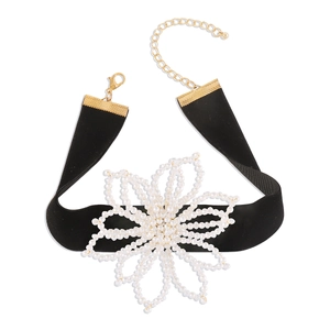 Elegant black velvet choker with a white pearl flower pendant and golden clasp