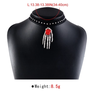 Detailed view of Gothic black lace choker featuring skeleton hand and red rose pendant