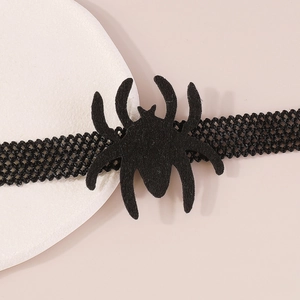 Macro view of gothic black spider choker featuring intricate lace and velvet texture