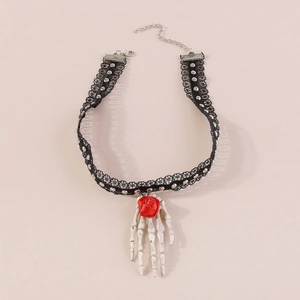 Detail of gothic lace choker featuring a skull hand pendant holding a red rose flower