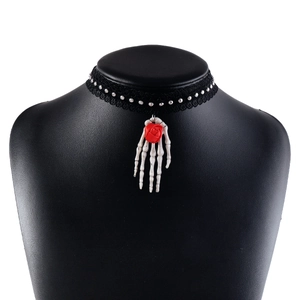 Detailed shot of Gothic lace choker featuring a skull hand pendant and a red 3D rose
