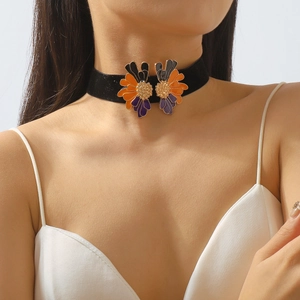 Vintage black velvet choker necklace featuring symmetrical colorful enamel flower charms