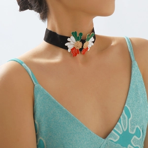 Detailed view of a black velvet choker with symmetrical tricolor floral enamel pendants