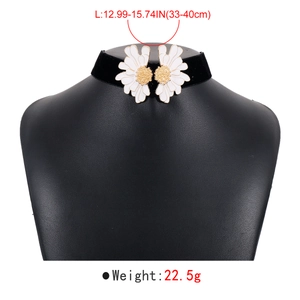 Detail of black velvet choker with white daisy flower charms and length measurement