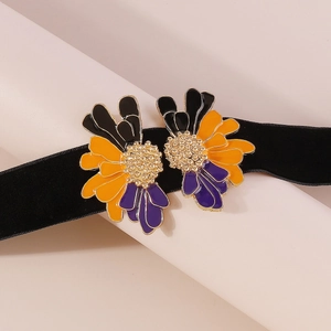 Detail of vintage velvet necklace with colorful enamel flowers and golden beaded centers