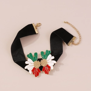 Detail of black velvet choker with gold floral pendants and colorful enamel petals