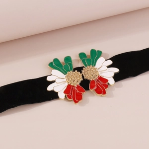 Macro view of vintage daisy enamel flower detail on black velvet ribbon choker