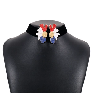 Detailed view of flocked choker with red blue oil-drip floral pendants on a black neck stand