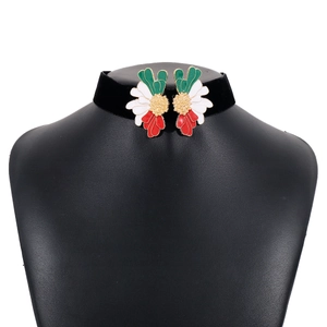 Detailed close-up of retro floral choker with tricolor enamel on black velvet band