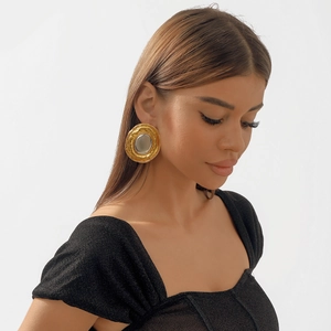 Exaggerated two-tone gold and silver round metal earrings with vintage wavy texture