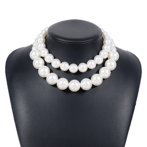 Elegant double-layer pearl choker necklace featuring lustrous white beads on a black stand