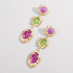 Detalle de pendientes geométricos dorados con incrustaciones de resina en color
