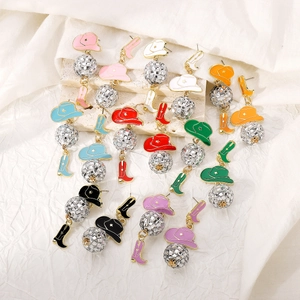 Detail of colorful cowboy hat and boot drop earrings with disco ball accents