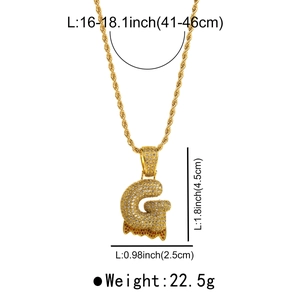 Detailed view of gold G-letter pendant with zircon stones and bubble lava design