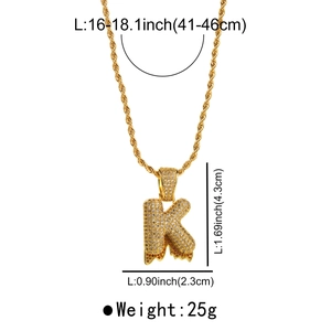 Macro shot of gold letter K necklace with micro-pave stones and lava drip detail