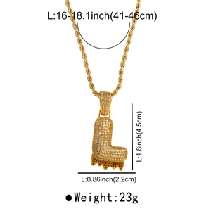 Detail view of gold letter L pendant with clear and orange zircons on a twist chain