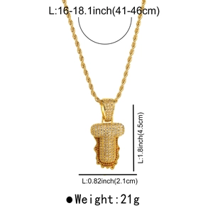 Detail of hip-hop gold letter T pendant with lava drip design and sparkling zircons