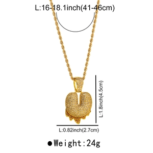 Close-up of golden letter U pendant with iced out cubic zirconia and dripping design