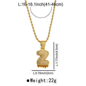 Close-up of gold lava letter Z pendant with cubic zirconia and twisted rope chain